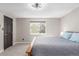 This primary bedroom features a large window, natural light, neutral colors, and a ceiling fan at 7367 Coors St, Arvada, CO 80005
