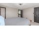 This primary bedroom has two doors, a ceiling fan, neutral colors, and two windows at 7367 Coors St, Arvada, CO 80005