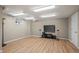 Finished basement area with wood flooring, recessed lighting, and a television setup, ideal for recreation at 7409 Mount Meeker Rd, Longmont, CO 80503