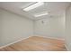 Unfurnished basement with wood flooring, featuring recessed lighting and a window for natural light at 7409 Mount Meeker Rd, Longmont, CO 80503