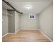Unfurnished basement space with modern flooring, wire rack shelving, and natural light from the window at 7409 Mount Meeker Rd, Longmont, CO 80503