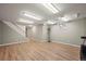 Spacious basement area with wood flooring, recessed lighting, and a staircase leading to the upper levels at 7409 Mount Meeker Rd, Longmont, CO 80503