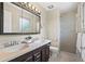 Bathroom featuring a double sink vanity, updated mirror, and glass-enclosed shower at 7409 Mount Meeker Rd, Longmont, CO 80503
