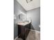 Modern bathroom features a dark vanity, stylish mirror, and sleek tile flooring at 7409 Mount Meeker Rd, Longmont, CO 80503