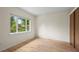 Bright bedroom featuring hardwood floors and a large window offering a view of lush greenery at 7409 Mount Meeker Rd, Longmont, CO 80503