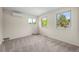 Well-lit bedroom featuring three windows with lots of natural light, and plush carpeting at 7409 Mount Meeker Rd, Longmont, CO 80503