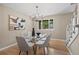 Modern dining room with glass table, stylish chairs, contemporary light fixture, and large window views at 7409 Mount Meeker Rd, Longmont, CO 80503