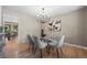 Modern dining room features a glass table, stylish seating, contemporary lighting, and a view to the kitchen at 7409 Mount Meeker Rd, Longmont, CO 80503