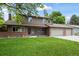 Charming home featuring a well-maintained lawn, brick accents and mature landscaping, enhancing its curb appeal at 7409 Mount Meeker Rd, Longmont, CO 80503