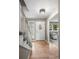 Bright foyer features gleaming hardwood floors, stylish lighting, and a staircase leading to the upper level at 7409 Mount Meeker Rd, Longmont, CO 80503