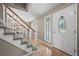 Elegant foyer featuring hardwood floors, staircase, and a decorative glass front door, creating a welcoming entrance at 7409 Mount Meeker Rd, Longmont, CO 80503