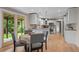 Eat-in kitchen boasts a cozy breakfast nook, light cabinets, granite countertops, and stainless steel appliances at 7409 Mount Meeker Rd, Longmont, CO 80503