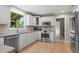 Bright kitchen featuring stainless steel appliances, white cabinets, and granite countertops at 7409 Mount Meeker Rd, Longmont, CO 80503