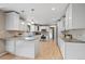 Bright, eat-in kitchen featuring granite countertops, white cabinetry, and stainless-steel appliances at 7409 Mount Meeker Rd, Longmont, CO 80503