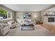 Bright living room with ample seating, modern decor, and stone fireplace at 7409 Mount Meeker Rd, Longmont, CO 80503