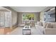 Comfortable living room featuring a large window for natural light and sight lines to the entry way at 7409 Mount Meeker Rd, Longmont, CO 80503