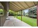 Covered patio offers a relaxing outdoor space overlooking the well-maintained lawn and mature landscaping at 7409 Mount Meeker Rd, Longmont, CO 80503