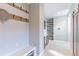 Mud room with tile floors, white bench, and hooks for storage at 15955 Humboldt Peak Dr, Broomfield, CO 80023