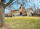 View of the backyard with a well-manicured lawn and an outdoor patio seating area at 8217 S Syracuse Ct, Centennial, CO 80112