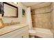 Bathroom with tub and shower, modern vanity, and a decorative tile border at 8217 S Syracuse Ct, Centennial, CO 80112