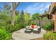 Landscaped backyard with patio furniture, string lights, and a wooden fence at 12355 E Arkansas Pl, Aurora, CO 80012