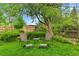 Inviting backyard lawn area with a small table and chair set and ambient lighting at 12355 E Arkansas Pl, Aurora, CO 80012