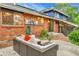 This backyard patio has a contemporary outdoor seating set and well-kept brick on the exterior of the home at 12355 E Arkansas Pl, Aurora, CO 80012