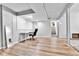 Basement area with desk, chair, mirror, wood-look floors, and updated paint at 12355 E Arkansas Pl, Aurora, CO 80012