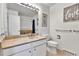 Well-lit bathroom with a marble countertop sink, toilet, shower and tasteful decor at 12355 E Arkansas Pl, Aurora, CO 80012