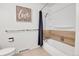 Clean bathroom showcasing a bathtub, shower with a navy curtain, and 