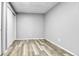 Empty bedroom featuring wood-look floors, fresh paint, and closet with sliding doors at 12355 E Arkansas Pl, Aurora, CO 80012