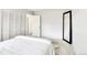 Minimal bedroom design with a large mirror and a comfortable bed at 12355 E Arkansas Pl, Aurora, CO 80012