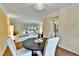 Bright dining room with hardwood floors, a modern chandelier, and views of the living area at 12355 E Arkansas Pl, Aurora, CO 80012
