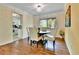 Bright dining room featuring hardwood floors, a classic chandelier, and backyard views at 12355 E Arkansas Pl, Aurora, CO 80012