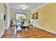 Cozy dining room with hardwood floors, a stylish chandelier, and ample natural light at 12355 E Arkansas Pl, Aurora, CO 80012
