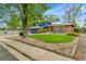 Charming home with stone and a grass yard next to the sidewalk at 12355 E Arkansas Pl, Aurora, CO 80012