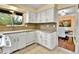 Bright kitchen featuring granite countertops, white cabinets and tile flooring at 12355 E Arkansas Pl, Aurora, CO 80012
