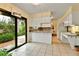 Bright kitchen with granite countertops, white cabinets, and a view of the backyard at 12355 E Arkansas Pl, Aurora, CO 80012