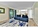 Comfortable living area with a blue modular sofa and a sliding glass door at 12355 E Arkansas Pl, Aurora, CO 80012