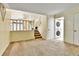Open floor plan living area near the staircase and laundry room at 12355 E Arkansas Pl, Aurora, CO 80012
