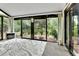 Bright sunroom with large windows, a view of the backyard, and carpet flooring at 12355 E Arkansas Pl, Aurora, CO 80012