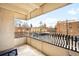 This balcony has iron railings, a textured wall, and a view of the neighborhood at 1365 Columbine St # 301, Denver, CO 80206