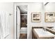 This is a well-lit bathroom with a white sink, framed picture, and an open door showing a shower at 1365 Columbine St # 301, Denver, CO 80206