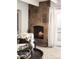 Living space featuring a cozy fireplace with stone surround and adjacent patio access at 1365 Columbine St # 301, Denver, CO 80206