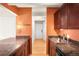 Well-maintained kitchen featuring dark wood cabinets, granite countertops, and a stylish faucet at 1365 Columbine St # 301, Denver, CO 80206