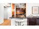 Kitchen pass-through with breakfast bar seating and modern lighting at 1365 Columbine St # 301, Denver, CO 80206