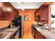 Updated kitchen boasts granite countertops, stainless steel appliances, and wood cabinets at 1365 Columbine St # 301, Denver, CO 80206