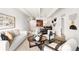 Bright, open living space with modern decor, white walls, and a view of the dining area and kitchen at 1365 Columbine St # 301, Denver, CO 80206