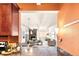 Cozy living room and kitchen featuring stone fireplace, comfortable seating, and a breakfast bar at 1365 Columbine St # 301, Denver, CO 80206
