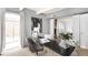 Home office with art, plant, black desk and view of living room with fireplace at 1365 Columbine St # 301, Denver, CO 80206